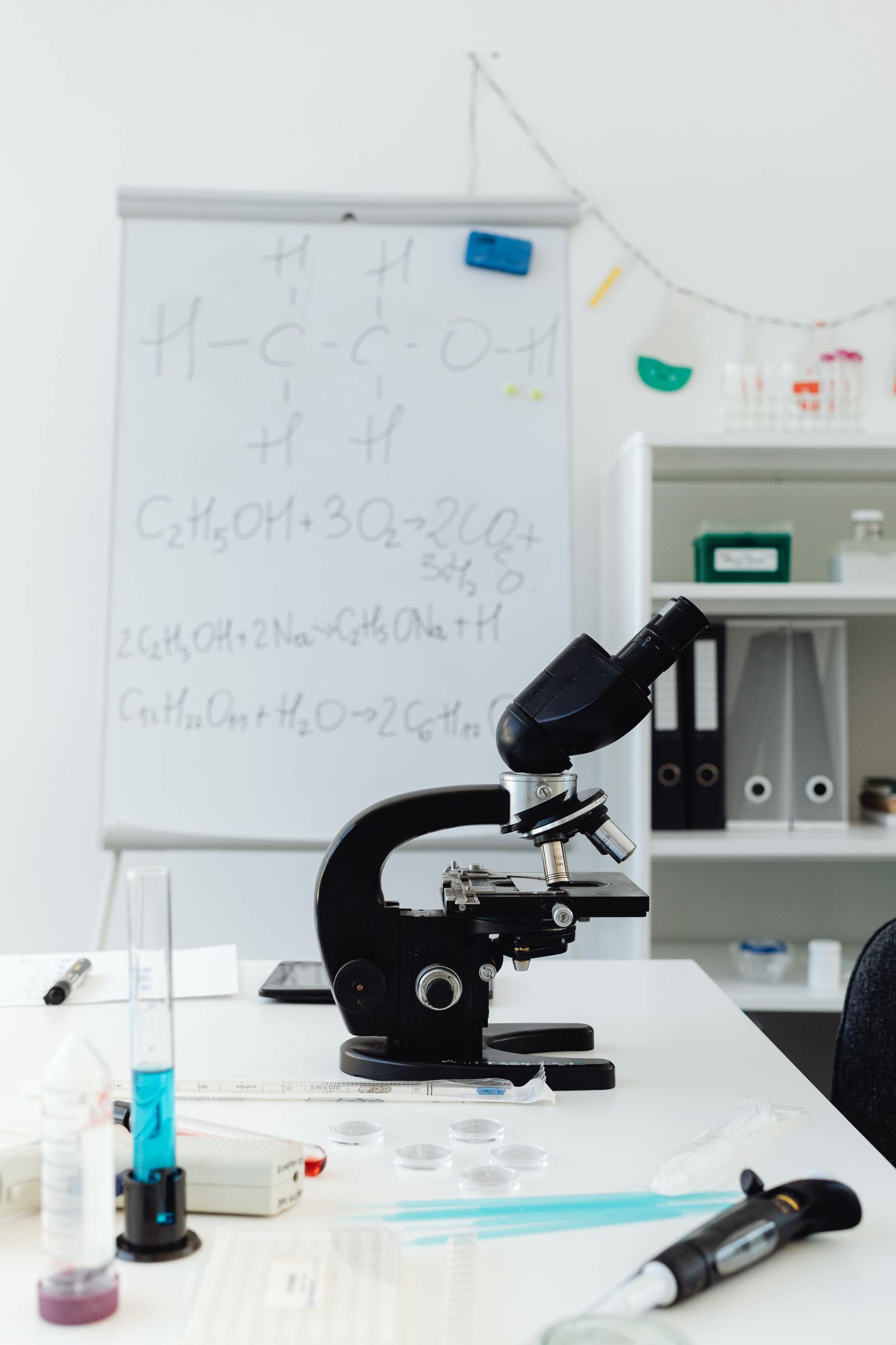 Microscope on a laboratory desk with scientific notes